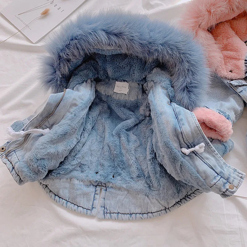 Blue girls' denim coat with a non-removable hood and fleece lining, shown on a hanger.