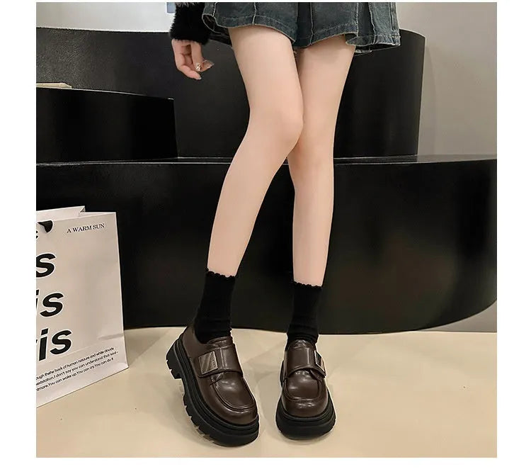 Women's black chunky heel British style shoes with square heel, cross strap, and round toe