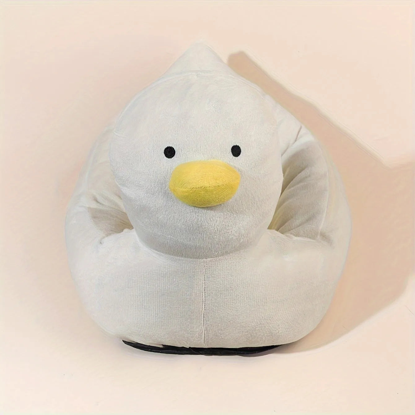 Blue duck-shaped fluffy pet bed for small dogs and cats on a wooden floor.