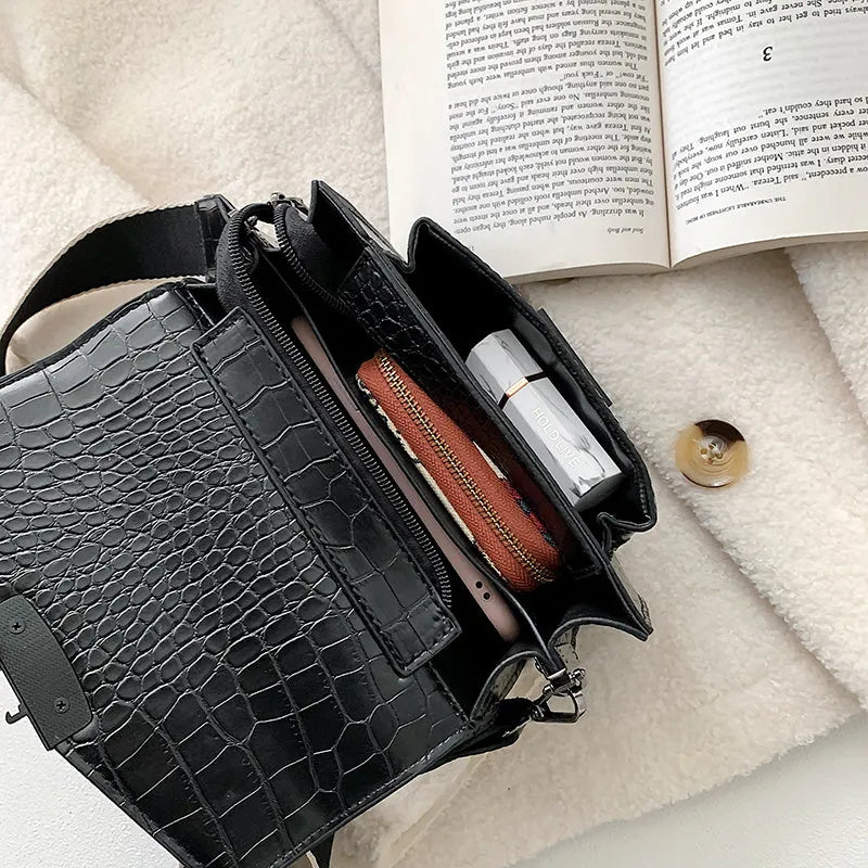 Vintage-style black PU crossbody bag with adjustable strap showing interior