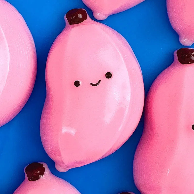 Chubby banana squeezing toy in pink TPR material for stress relief