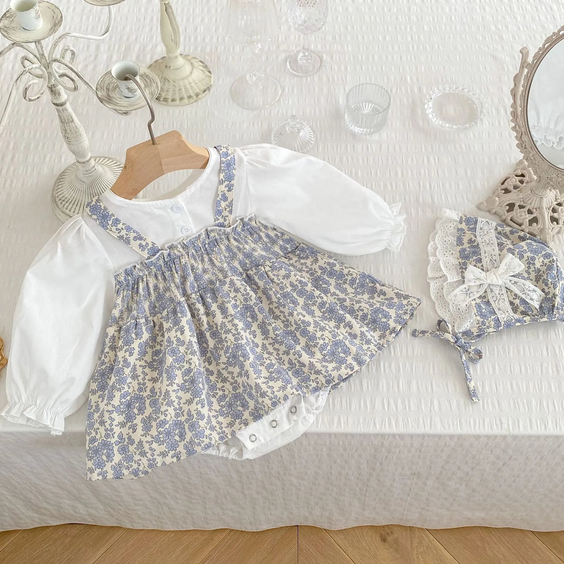 White cotton baby girl floral princess fake two triangle romper with removable hood, long sleeves, front view