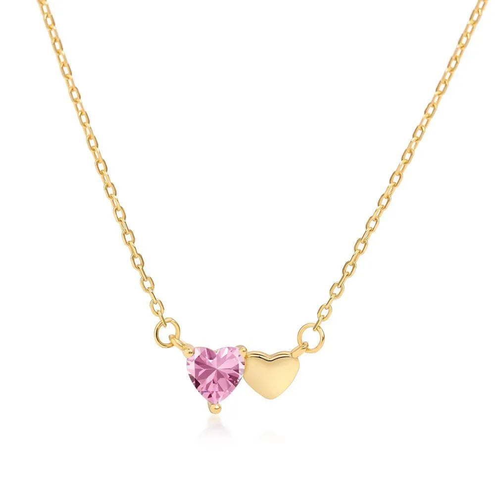 925 silver heart necklace with emerald zircon in gold finish on display
