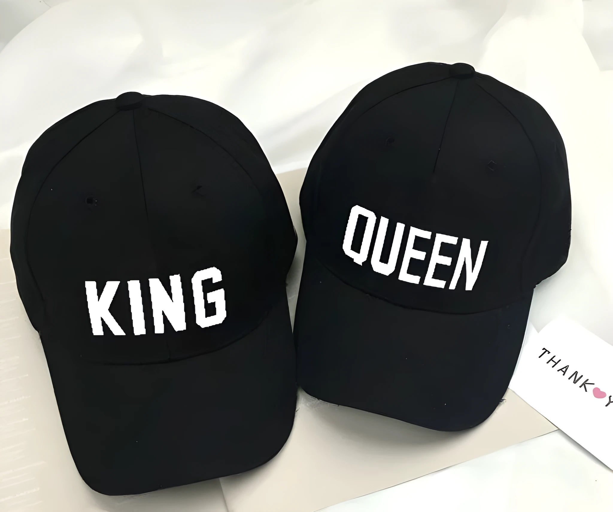 Black printed baseball cap with King design on front, adjustable back strap, on white background