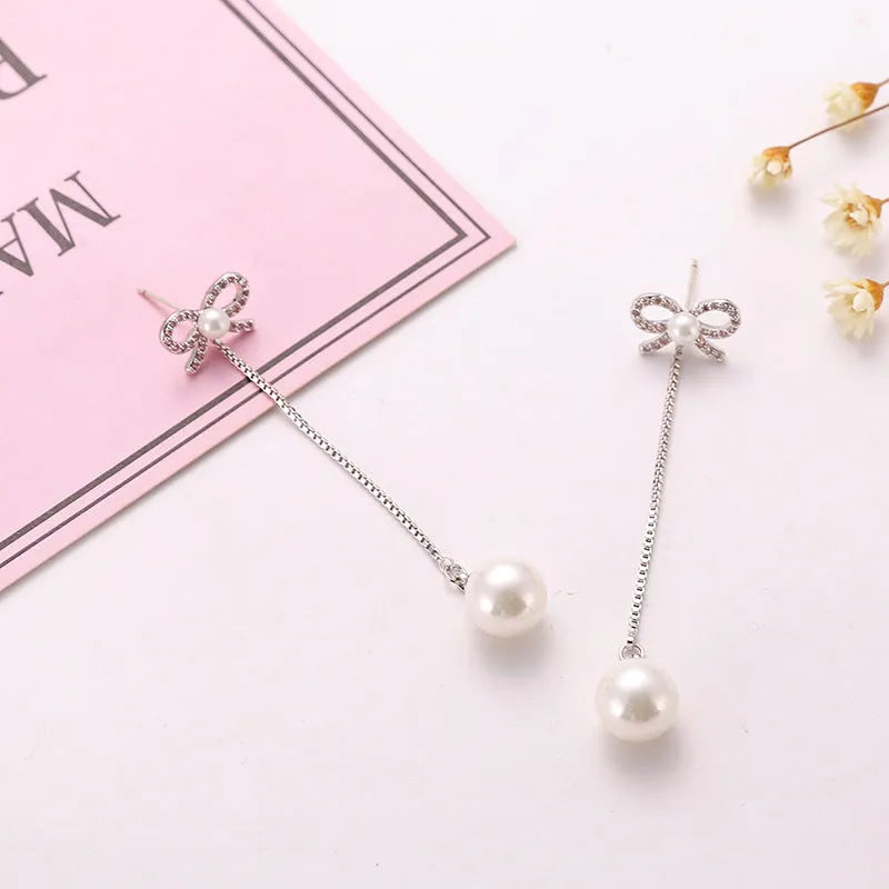 Sterling silver bow earrings with long pearl pendant, hypoallergenic copper construction, women's two-way style