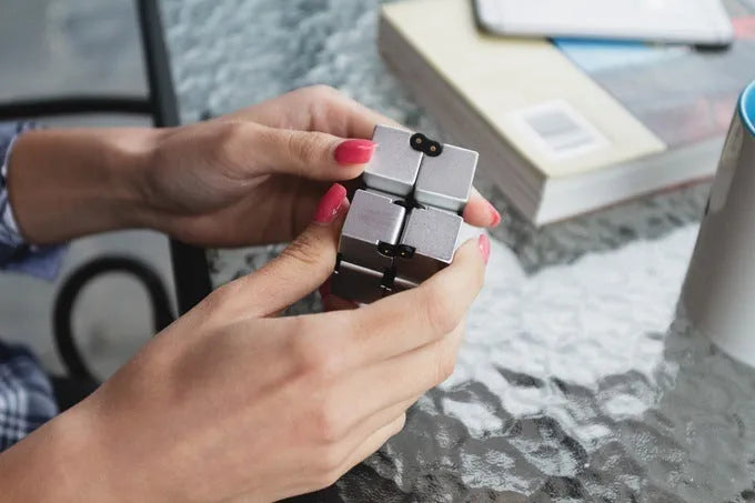 Zinc alloy infinity cube fidget toy showing rotating cube mechanism in metallic finish