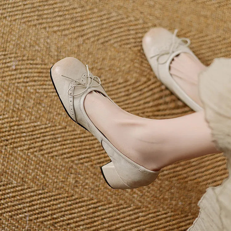 Women's round toe mid heel chunky leather pumps in solid colour with bow detail