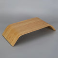 Walnut laptop stand with stability bracket in bamboo leather colour on a desk