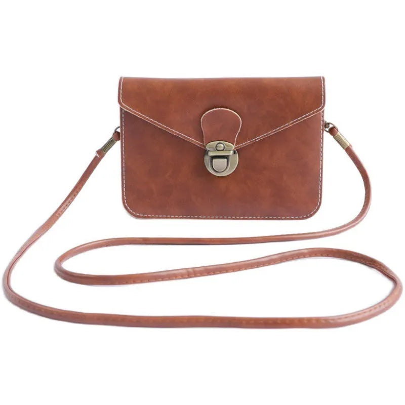 Soft surface crossbody messenger bag with flap closure and lock hardware in wine red colour