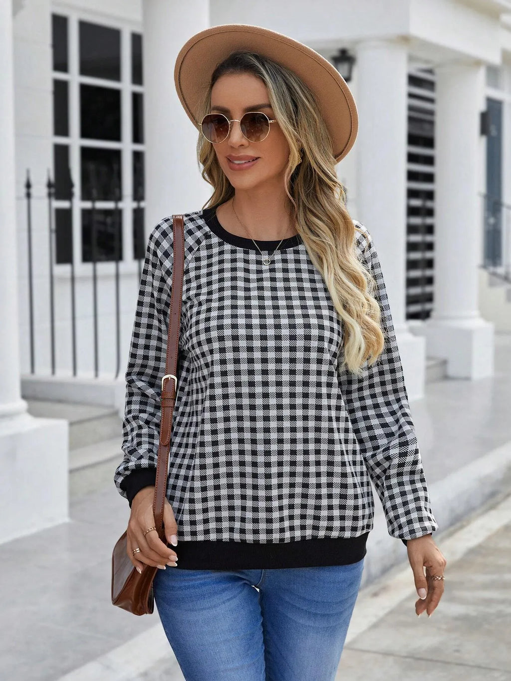 Black long sleeve polyester sweater with a plaid pattern, shown on a hanger.