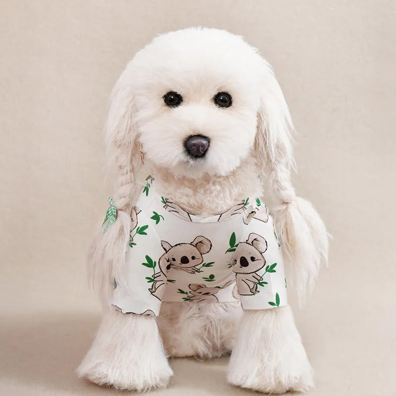 A small dog wearing a colourful, printed polyester t-shirt, showing the full chest design and fit.