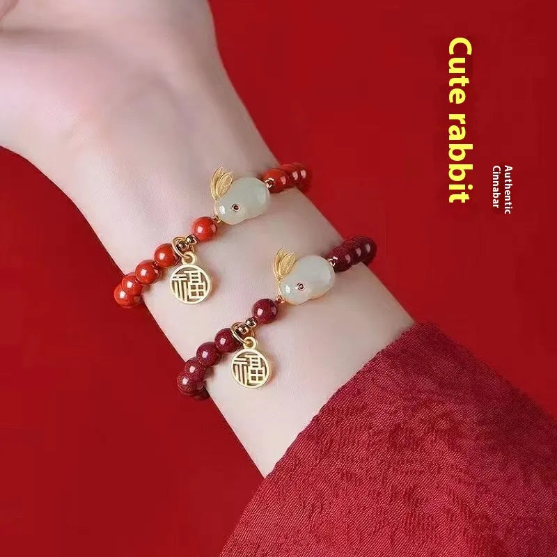 Purple gold sand cinnabar bracelet with jade hare charm in 6mm and 8mm bead sizes.