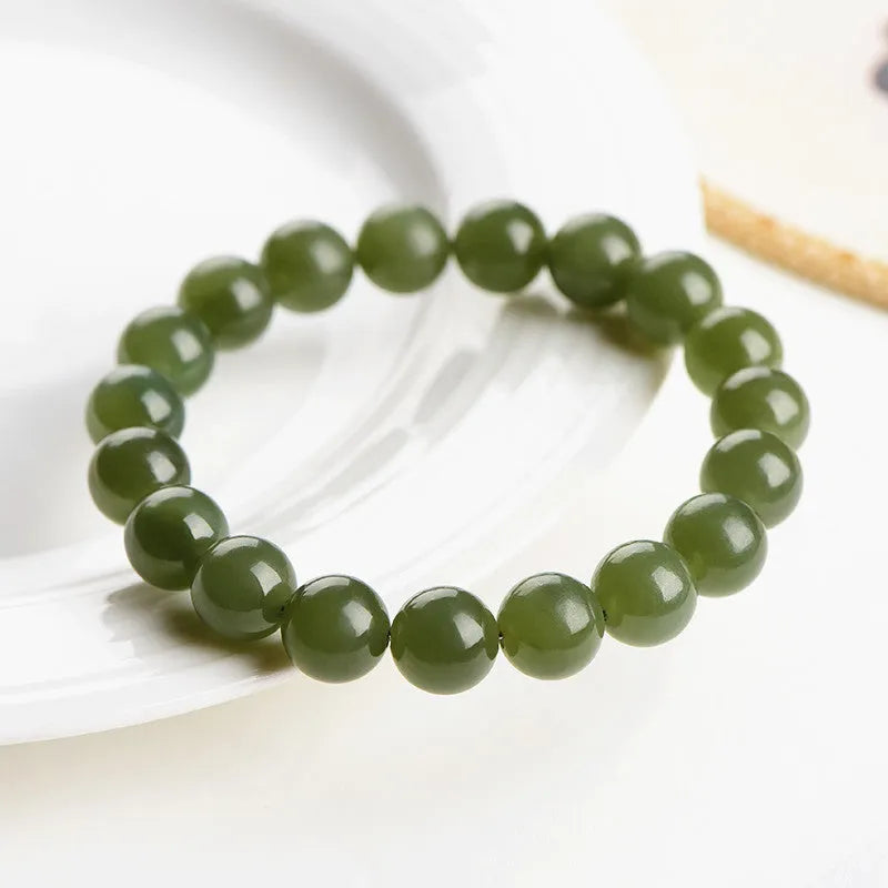 Polished Hetian jade bead bracelet in ice-like clear colours on a white background.