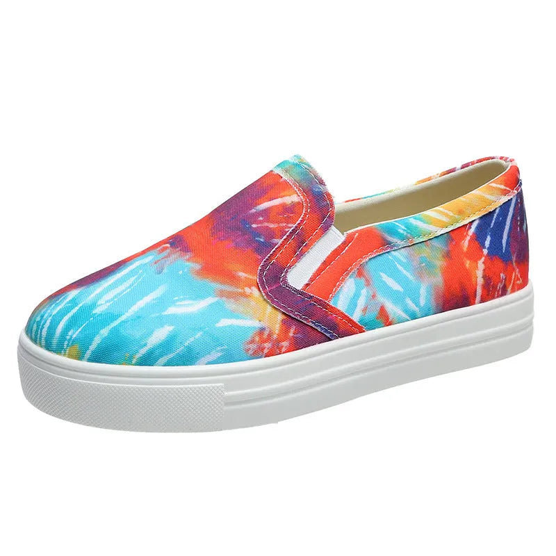 Women's low-top canvas slip-on sneaker in multiple colours, showing flat rubber sole and slip-on design.