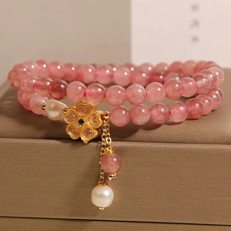 Double ring women's bracelet with strawberry quartz four-leaf clover charms and alloy gemstone details.