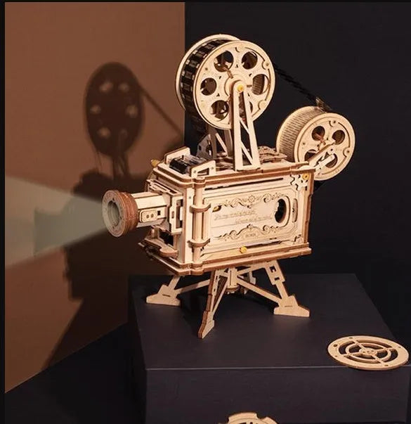 Wooden three-dimensional puzzle film projector with hand crank and gear wheel assembly