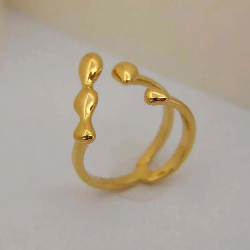 Adjustable brass ring with sphere design in gold or silver plating.