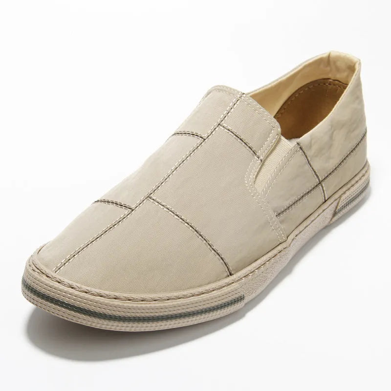Men's low-top slip-on canvas shoes in multiple colours with round toe and flat rubber sole.