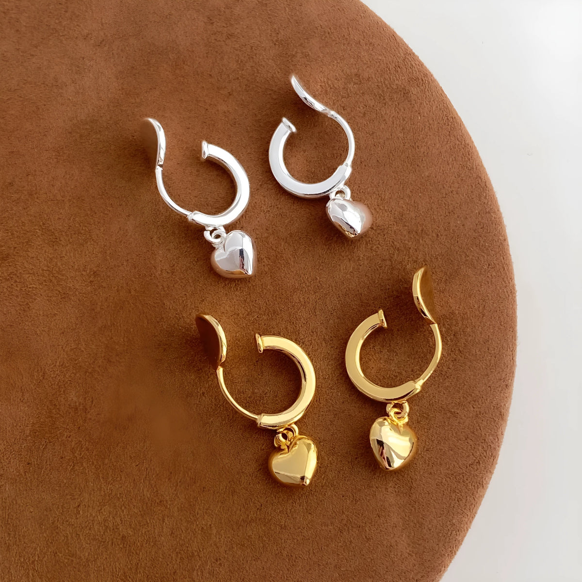 Copper heart-shaped earrings in gold and silver electroplate, available as ear clips or studs for women