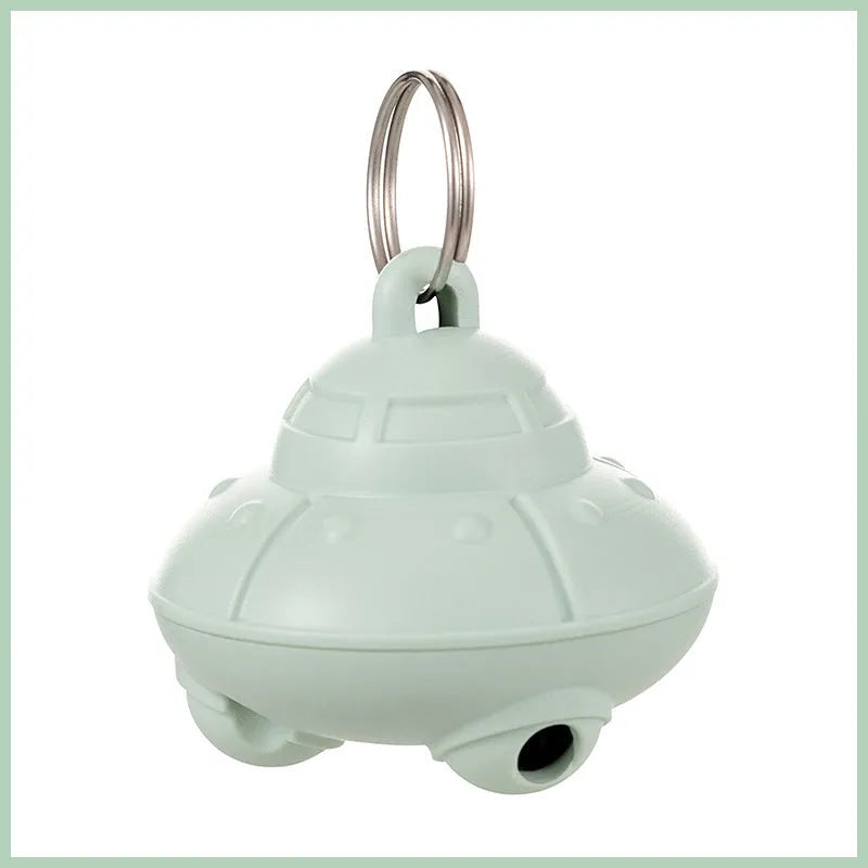 Automatic cat laser toy attached to green collar with USB charging port visible