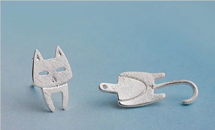 S925 sterling silver stud earrings with asymmetrical cat and fish design on white background