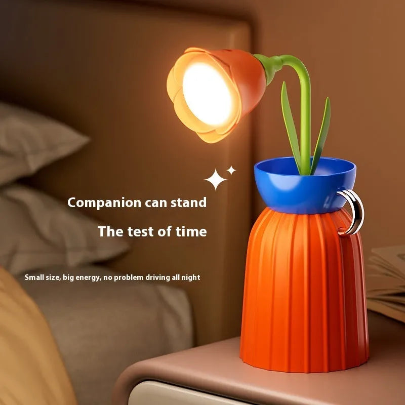 LED flower lamp in pink rose style with USB cable, 30cm tall, on a bedroom table