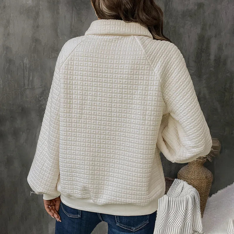 Women's beige thick polo collar long sleeve sweater laid flat.