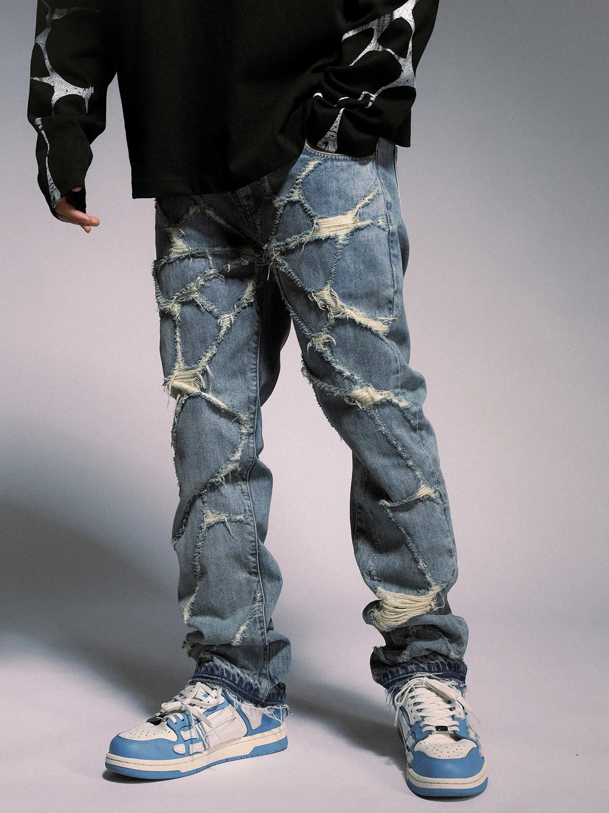 High street wash destroyed spider web straight leg jeans in light blue denim, mid-waist zipper front
