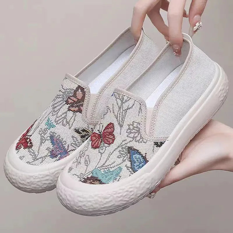 Women's slip-on canvas shoes in Black with round toe and decorative sewing thread details
