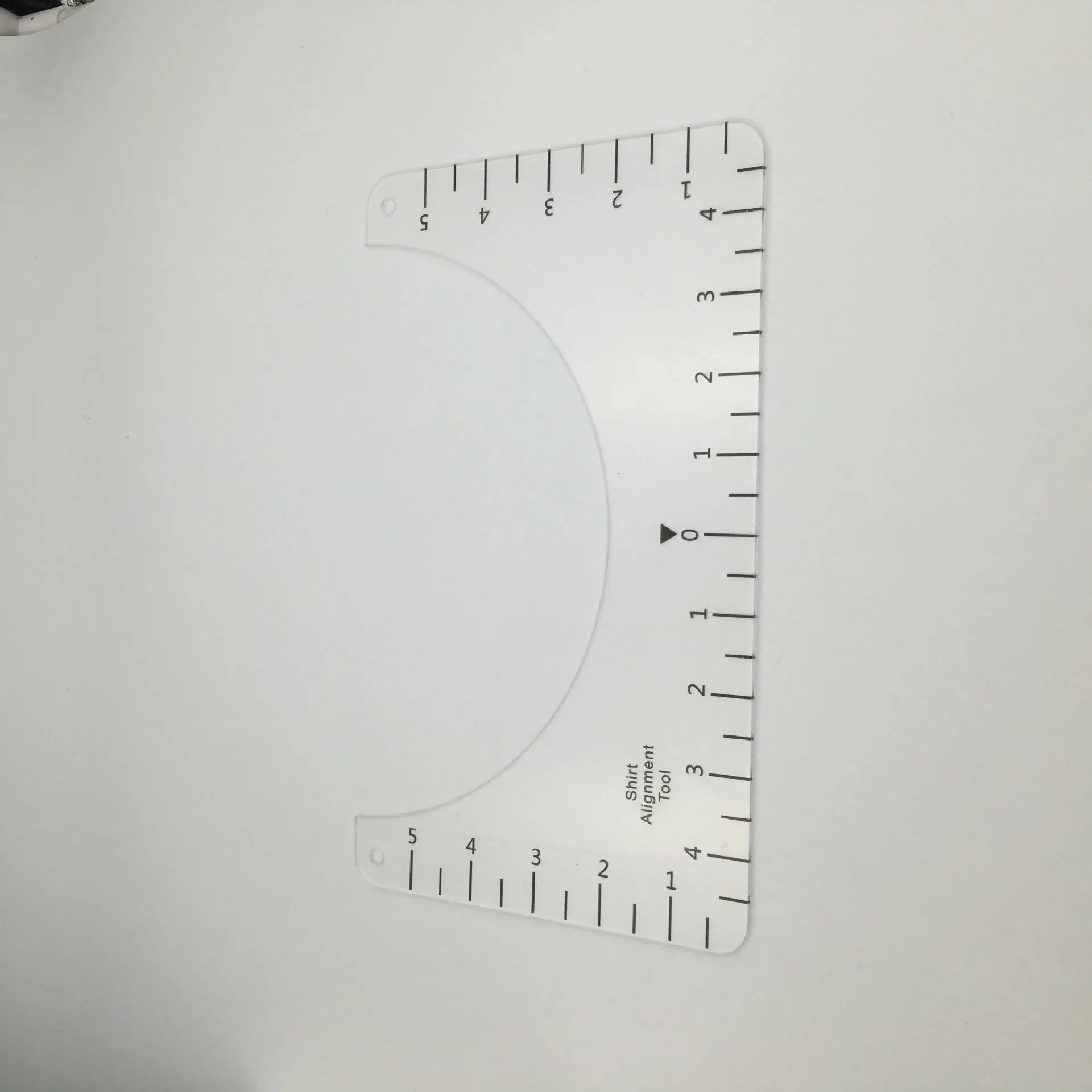 Clear acrylic sewing patch ruler for T-shirt alignment, 10 by 6 inches.