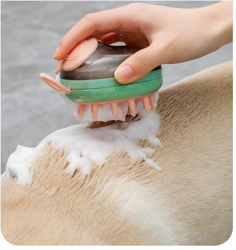 Blue 2-in-1 pet bathing brush with silicone head and integrated shampoo dispenser held in a hand.