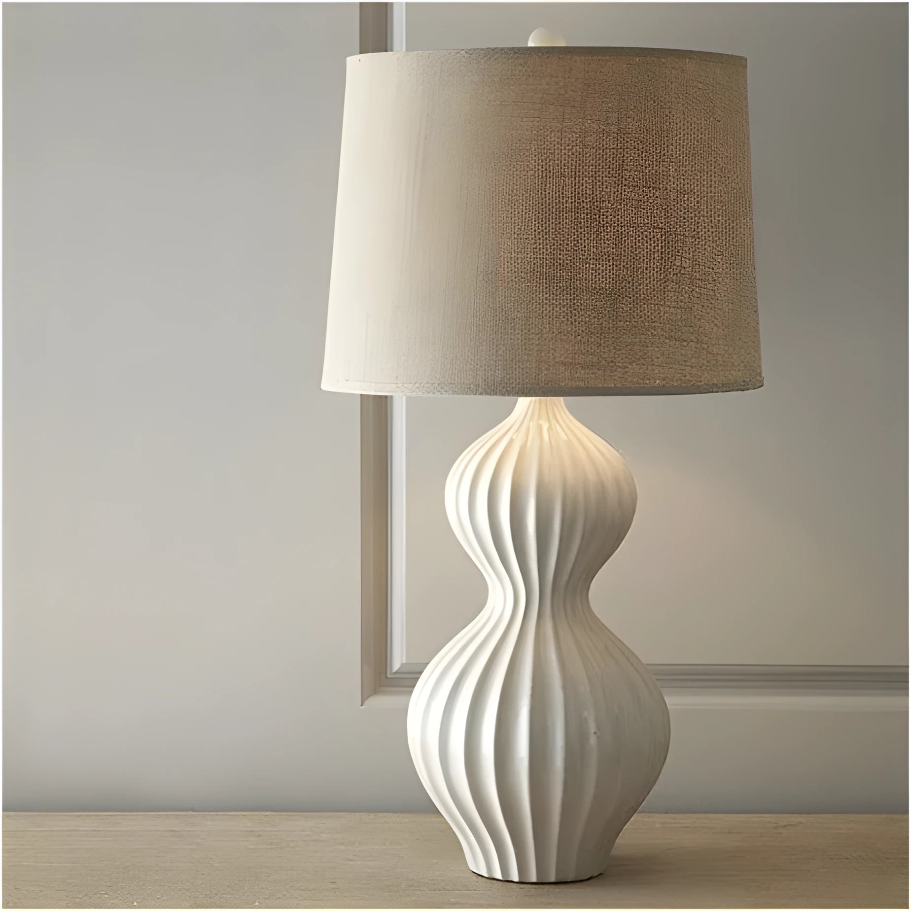 Jingdezhen ceramic table lamp with white fabric shade on wooden table