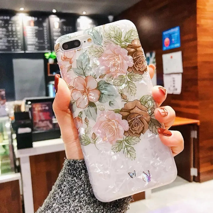 Dream Shell soft TPU iPhone case with rose flower design in purple, shown on a phone.