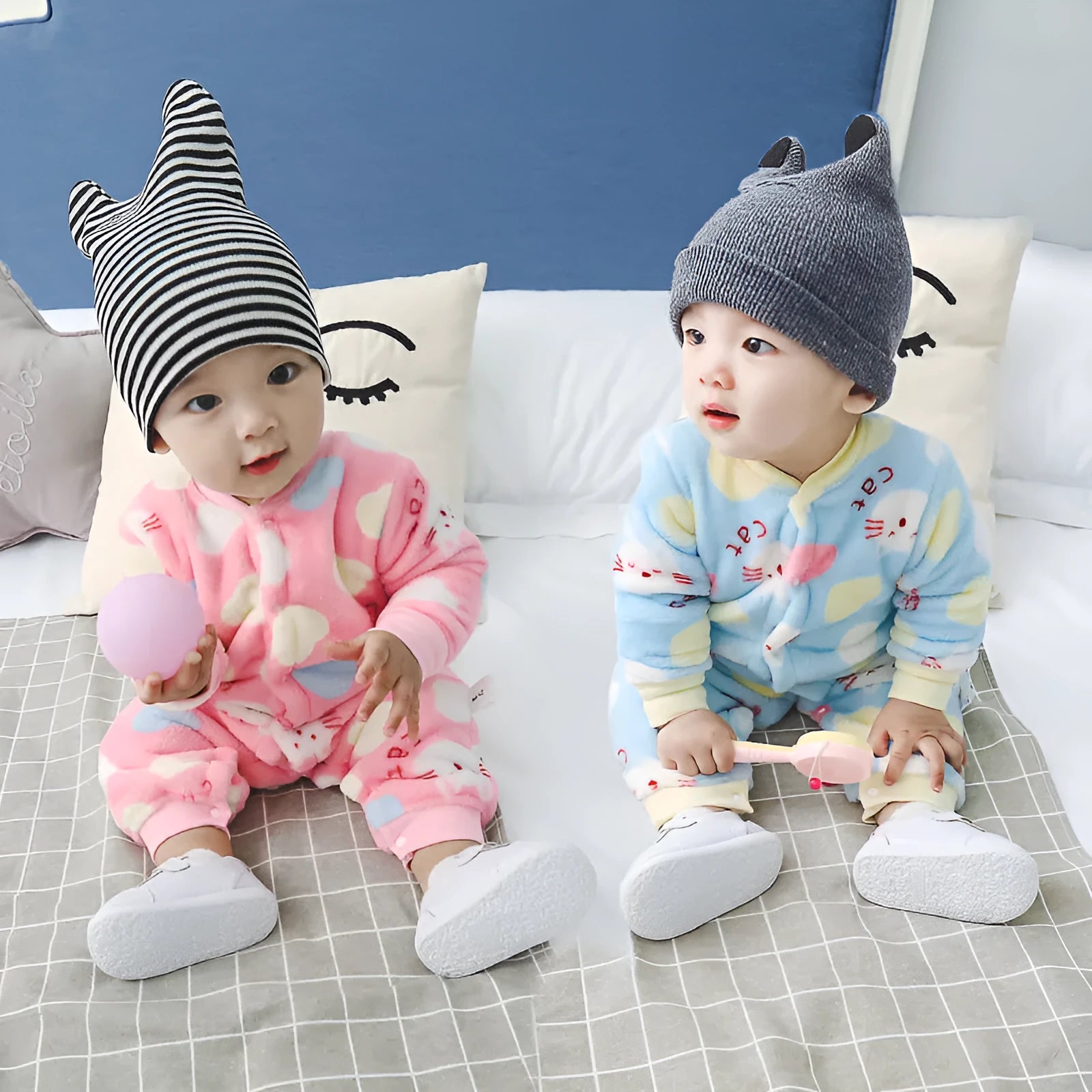 Baby wearing a long-sleeved flannel romper in a pink bunny head print, showcasing the 100% cotton fabric.