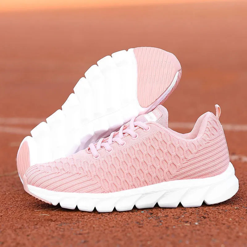Women's running shoes in black with detailed view of fly weaving upper material and wear-resistant rubber outsole.