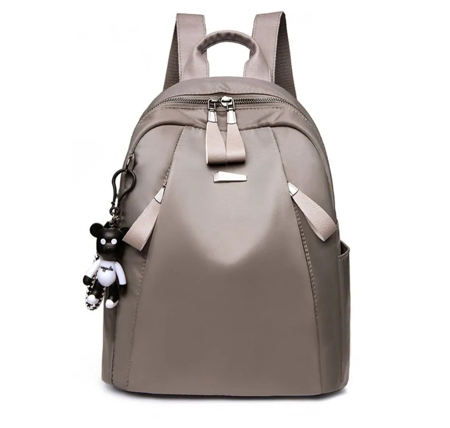 Medium square Oxford cloth rucksack in wine red with double straps and a front patch pocket.