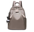 Medium square Oxford cloth rucksack in wine red with double straps and a front patch pocket.