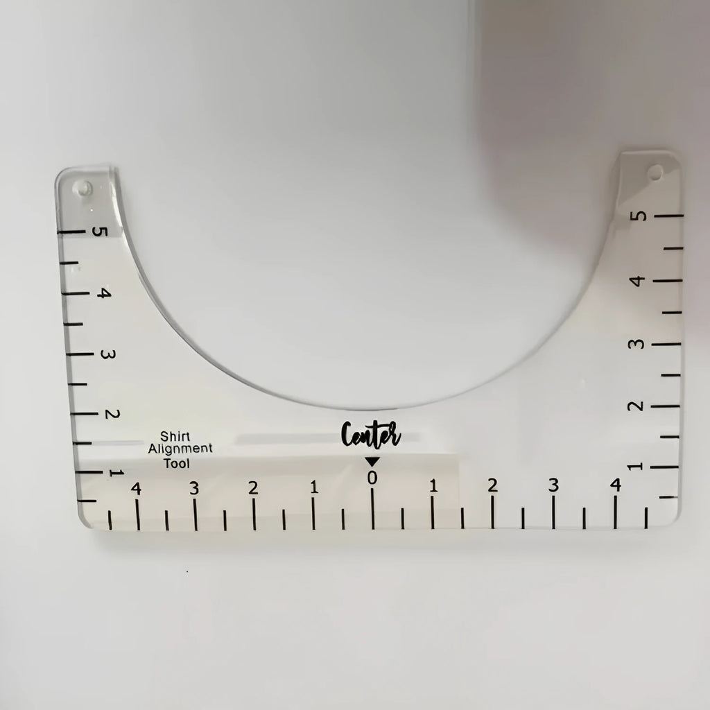 Clear acrylic sewing patch ruler for T-shirt alignment, 10 by 6 inches.
