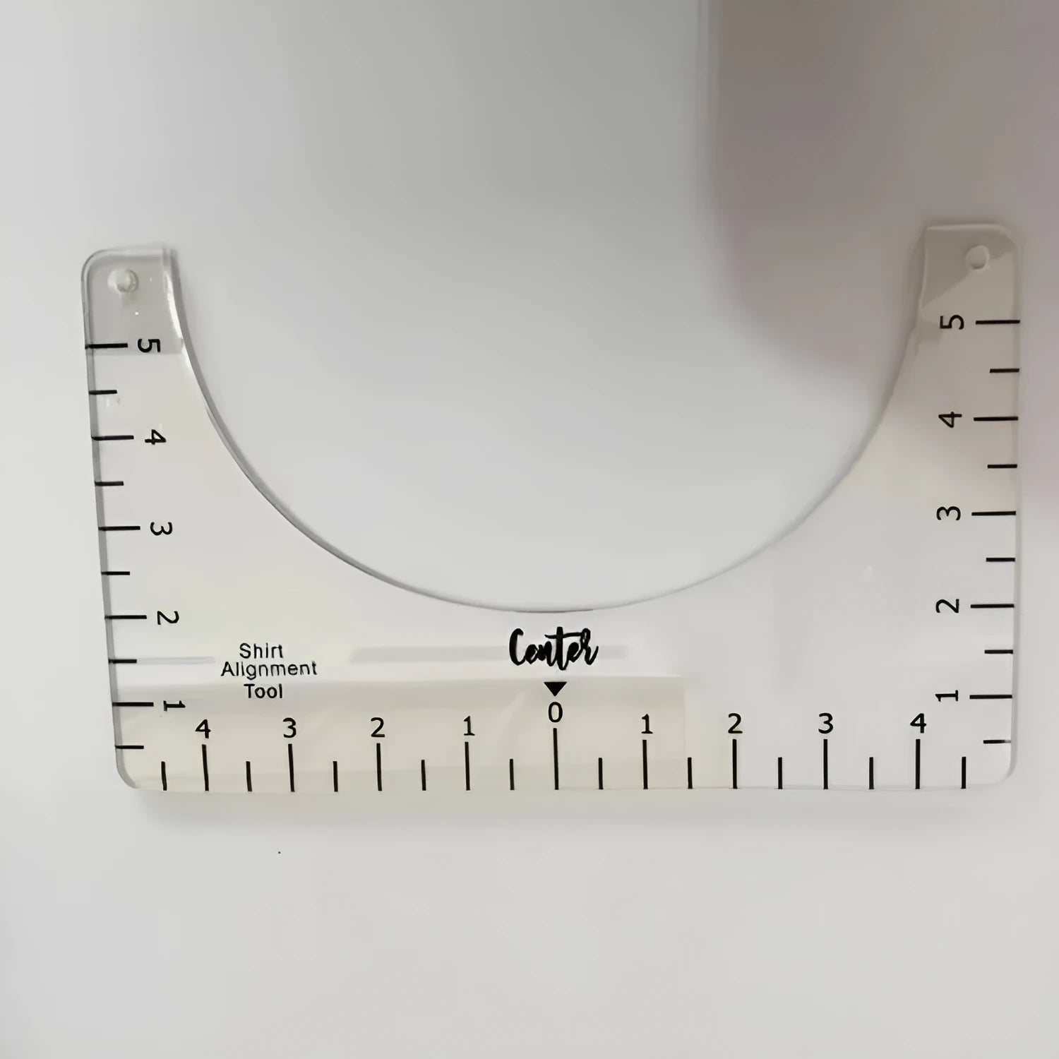 Clear acrylic sewing patch ruler for T-shirt alignment, 10 by 6 inches.