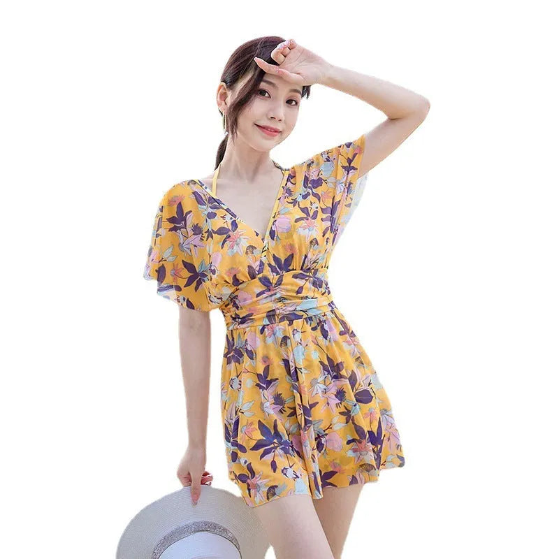 Yellow floral pattern women's one-piece swimsuit on a hanger showing front design