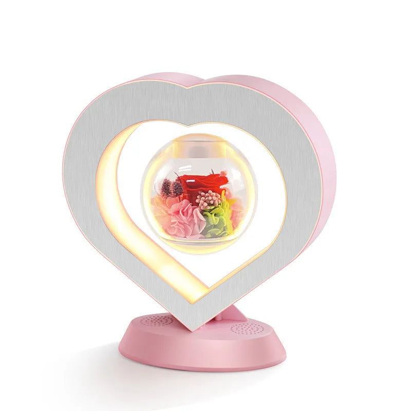 Magnetic levitation lamp with pink eternal rose inside transparent sphere and Bluetooth speaker on USB base