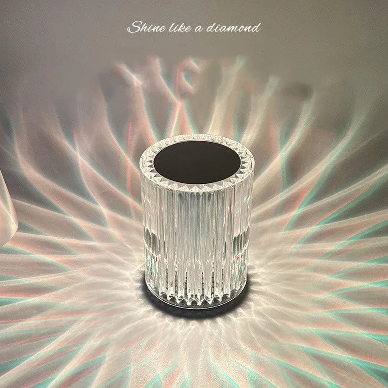 Compact acrylic crystal LED table lamp with RGB colours and remote control on a desk