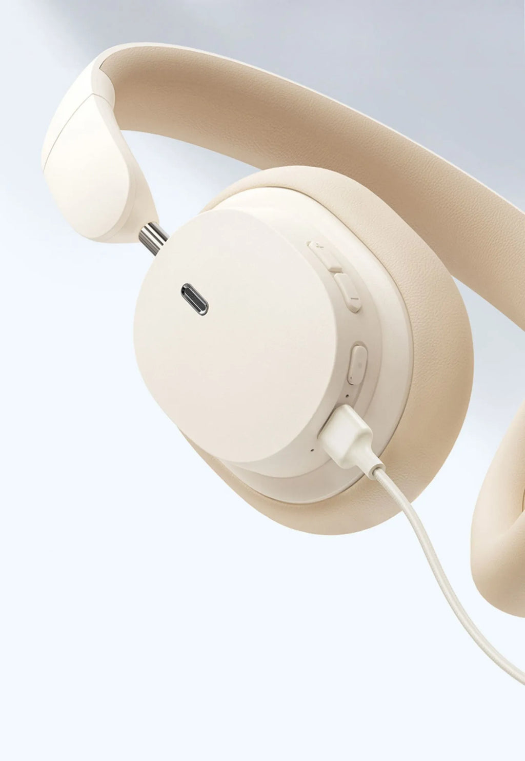 Beige over-ear wireless Bluetooth headset with noise cancellation on display