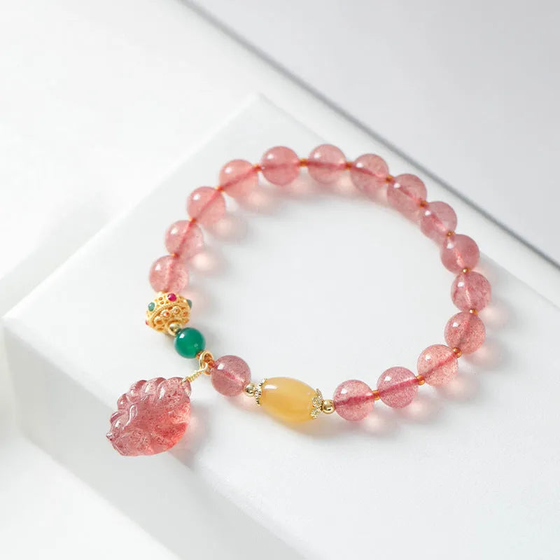 Women's crystal bracelet with nine tail fox design in polished natural strawberry quartz beads