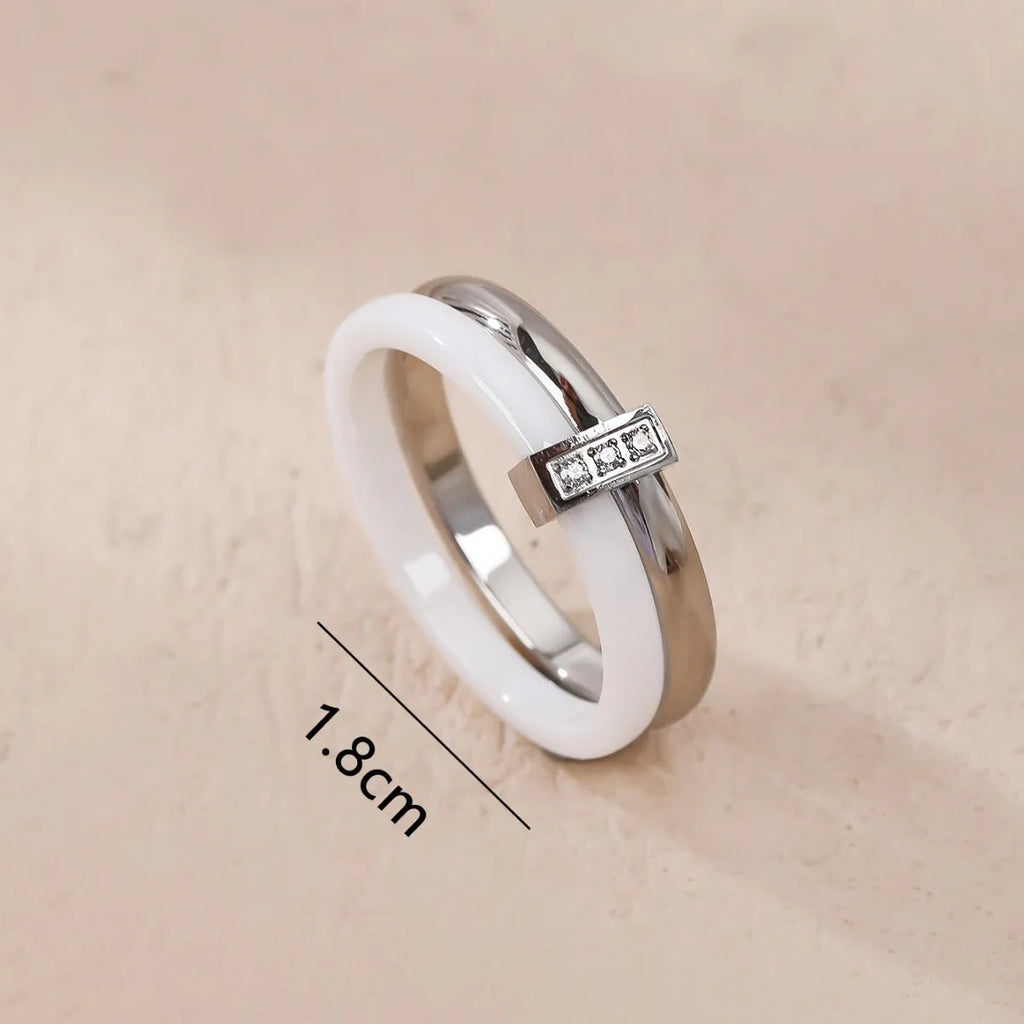Women's titanium steel heart-shaped double ring with glossy stitching and inlaid zirconium detail.