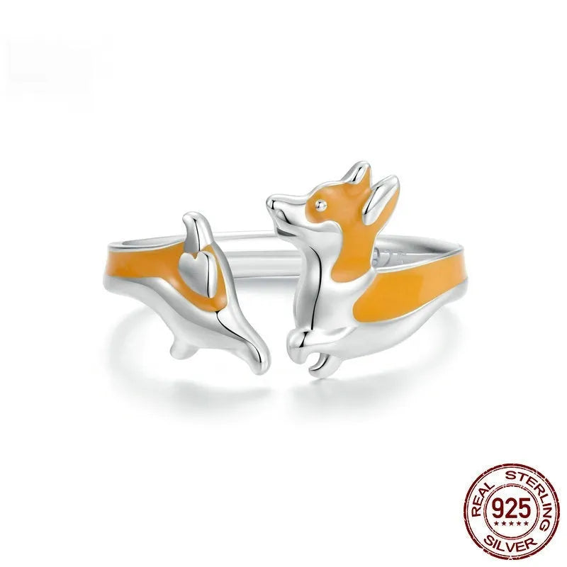 Silver ring with a raised cartoon corgi dog design on the band.
