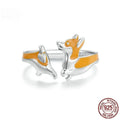 Silver ring with a raised cartoon corgi dog design on the band.