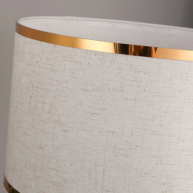 Desk lamp with iron base and fabric shade in choice of black, gold or white colours