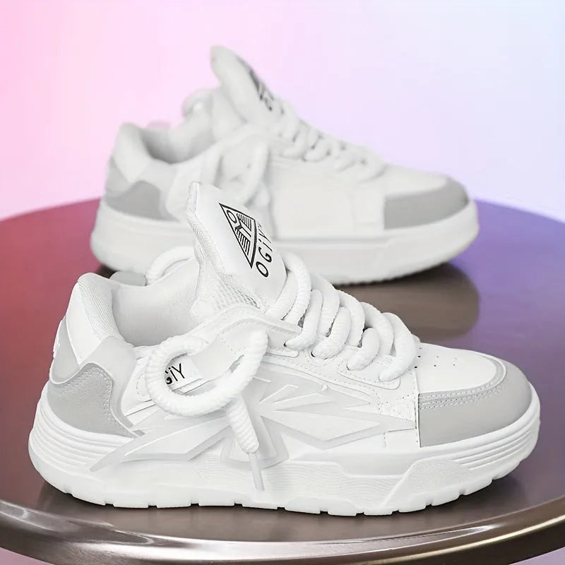 Men's white chunky sneakers with a cartoon pattern, round toe, and thick rubber sole on a plain background.