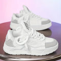 Men's white chunky sneakers with a cartoon pattern, round toe, and thick rubber sole on a plain background.